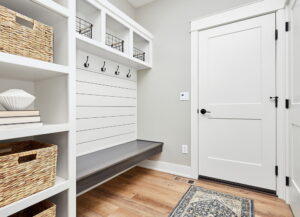 A clean, organized hallway or entryway with baskets and neatly arranged storage.