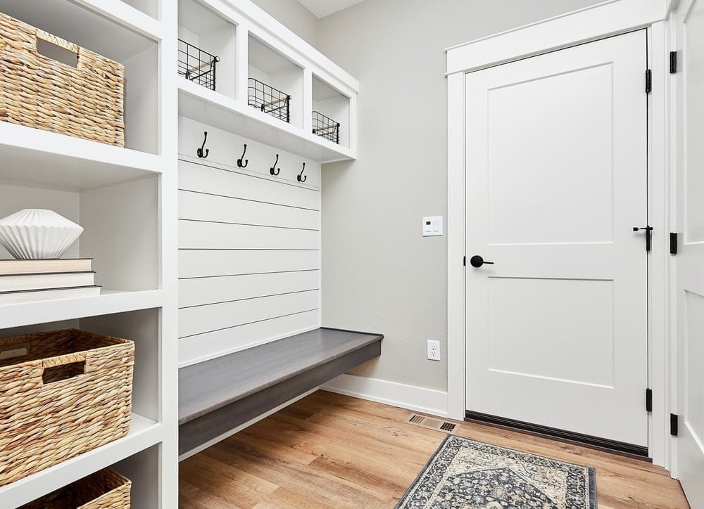 A clean, organized hallway or entryway with baskets and neatly arranged storage.